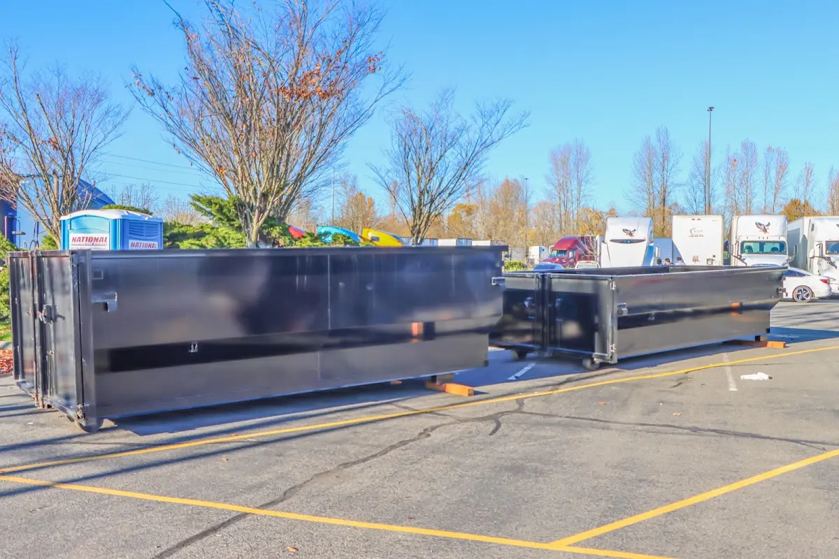 Professional dumpster rental service with roll-off container on residential driveway in New Franklin